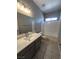 Bathroom showcasing a modern vanity, mirror, and shower-tub combo at 2694 Hillgrass Rd, Las Vegas, NV 89123