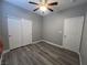 Cozy bedroom featuring a ceiling fan, window, and closet doors at 2694 Hillgrass Rd, Las Vegas, NV 89123