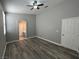 Bedroom with sleek flooring, ceiling fan, and a glimpse of the bathroom at 2694 Hillgrass Rd, Las Vegas, NV 89123