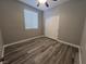 This bedroom features a ceiling fan, natural light, and sleek flooring at 2694 Hillgrass Rd, Las Vegas, NV 89123