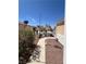 Charming front yard featuring desert landscaping, a sidewalk, and unique decorative outdoor lighting at 2694 Hillgrass Rd, Las Vegas, NV 89123