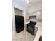 Efficient kitchen layout with gray cabinets and updated appliances for meal preparation at 2694 Hillgrass Rd, Las Vegas, NV 89123