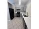 Updated kitchen featuring gray cabinets, stainless steel appliances, and tile flooring at 2694 Hillgrass Rd, Las Vegas, NV 89123