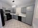 Modern kitchen with gray cabinets, stainless steel appliances, and quartz countertops at 2694 Hillgrass Rd, Las Vegas, NV 89123