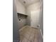 Neutral laundry room features tiled floor, door and an overhead shelf at 2694 Hillgrass Rd, Las Vegas, NV 89123