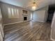 Open-concept living room with a fireplace, neutral paint, and luxury vinyl plank flooring at 2694 Hillgrass Rd, Las Vegas, NV 89123