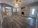 Spacious living room featuring a cozy fireplace, ceiling fan and white plantation shutters at 2694 Hillgrass Rd, Las Vegas, NV 89123
