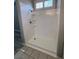 All white walk-in shower with shelves and tiled floor at 2694 Hillgrass Rd, Las Vegas, NV 89123