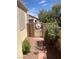 Enclosed side yard with decorative gate, desert landscaping, and easy access to the home at 2694 Hillgrass Rd, Las Vegas, NV 89123
