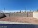 Spacious backyard featuring a concrete patio and low-maintenance desert landscaping at 2711 Morning Break Ct, Las Vegas, NV 89142