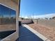 Spacious backyard featuring a concrete patio and low-maintenance desert landscaping at 2711 Morning Break Ct, Las Vegas, NV 89142