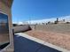 Spacious backyard featuring a concrete patio and low-maintenance desert landscaping at 2711 Morning Break Ct, Las Vegas, NV 89142