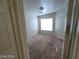 Cozy bedroom featuring plush carpeting, a ceiling light, and a window for natural light at 2711 Morning Break Ct, Las Vegas, NV 89142