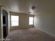 This bedroom offers natural light from two windows and features an en-suite bathroom at 2711 Morning Break Ct, Las Vegas, NV 89142