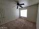 Bedroom featuring a ceiling fan, neutral carpeting, and natural light at 2711 Morning Break Ct, Las Vegas, NV 89142