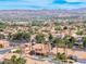 Panoramic aerial view showcases the property within a vast neighborhood, set against a backdrop of impressive mountains and the city skyline at 2741 Chokecherry Ave, Henderson, NV 89074