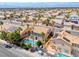 Sprawling neighborhood showcases homes with private pools and desert landscaping, framed by palm trees and terracotta roofs from above at 2741 Chokecherry Ave, Henderson, NV 89074
