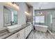 Modern bathroom featuring double sinks, soaking tub, and glass enclosed shower at 2741 Chokecherry Ave, Henderson, NV 89074