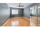 Bedroom featuring wood floors, a ceiling fan, window and closet with mirrored doors at 2741 Chokecherry Ave, Henderson, NV 89074