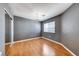 Bedroom features wood floors, gray walls, a window and closet with mirrored doors at 2741 Chokecherry Ave, Henderson, NV 89074