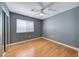 Bedroom featuring wood floors, a ceiling fan, window and closet with mirrored doors at 2741 Chokecherry Ave, Henderson, NV 89074