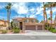 Beautiful two-story home boasts a three-car garage and manicured landscaping with swaying palm trees against a vibrant sky at 2741 Chokecherry Ave, Henderson, NV 89074
