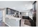Modern kitchen boasts sleek black cabinets, stainless steel appliances, and mosaic tile backsplash at 2741 Chokecherry Ave, Henderson, NV 89074