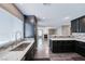 Stylish kitchen boasts modern sink, gray counters, and view to living room fireplace at 2741 Chokecherry Ave, Henderson, NV 89074