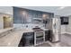 Elegant kitchen featuring black cabinets, stainless steel appliances, and marble countertops at 2741 Chokecherry Ave, Henderson, NV 89074