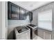 Laundry room features upper cabinets and a side-by-side washer and dryer at 2741 Chokecherry Ave, Henderson, NV 89074