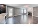 Open living room with gray walls, fireplace, wood floors, and pool access via glass door at 2741 Chokecherry Ave, Henderson, NV 89074