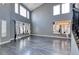 Spacious living room features vaulted ceilings, large windows, and stylish gray wood flooring at 2741 Chokecherry Ave, Henderson, NV 89074