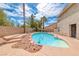 Backyard pool with rock features, concrete patio and rock landscaping at 2741 Chokecherry Ave, Henderson, NV 89074