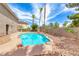 A backyard swimming pool with palm trees, rock features and desert landscaping at 2741 Chokecherry Ave, Henderson, NV 89074