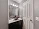 Modern powder room featuring a vessel sink and decorative mirror and lighting at 2741 Chokecherry Ave, Henderson, NV 89074