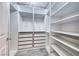 Spacious walk-in closet with custom shelving and drawers for optimal organization at 2741 Chokecherry Ave, Henderson, NV 89074