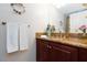 Bathroom featuring granite countertops and dark wood cabinets, with decorative wall hangings at 2749 Lodestone Dr, Las Vegas, NV 89117