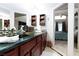 Bathroom features a dark vanity, granite countertop, and access to the bedroom at 2749 Lodestone Dr, Las Vegas, NV 89117