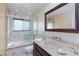 Bathroom featuring neutral tile, a shower/tub combo, and a vanity with a vessel sink at 2749 Lodestone Dr, Las Vegas, NV 89117