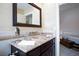 Bathroom featuring neutral tile, a large mirror, and vanity with a vessel sink at 2749 Lodestone Dr, Las Vegas, NV 89117