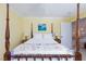 Bedroom with four-poster bed, neutral colors, ceiling fan and adjacent bathroom at 2749 Lodestone Dr, Las Vegas, NV 89117