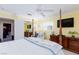 Bedroom with four-poster bed, tv, chair, and adjacent closet room/storage space at 2749 Lodestone Dr, Las Vegas, NV 89117