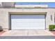 A standard white garage door with exterior lighting at 2749 Lodestone Dr, Las Vegas, NV 89117