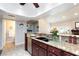 Open kitchen featuring granite countertops, dark wood cabinets, and stainless steel dishwasher at 2749 Lodestone Dr, Las Vegas, NV 89117