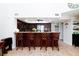 Kitchen with breakfast bar, stainless steel appliances, and dark wood cabinets at 2749 Lodestone Dr, Las Vegas, NV 89117