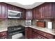 Kitchen area with modern appliances, including an oven, microwave, and granite countertops at 2749 Lodestone Dr, Las Vegas, NV 89117