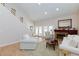 Bright living room features a fireplace, staircase, and double doors to the outside at 2749 Lodestone Dr, Las Vegas, NV 89117