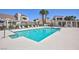 Community pool with clear water, multiple lounge chairs, pergola, and desert landscaping at 2749 Lodestone Dr, Las Vegas, NV 89117