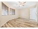 This bedroom features two windows, wood-look flooring, and a ceiling fan at 2836 Linkview Dr, Las Vegas, NV 89134