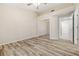 The bedroom showcases a mirrored closet, neutral walls, and wood-look flooring for a modern touch at 2836 Linkview Dr, Las Vegas, NV 89134